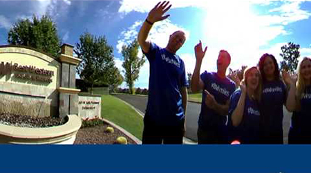 People waving outside of Best Western
