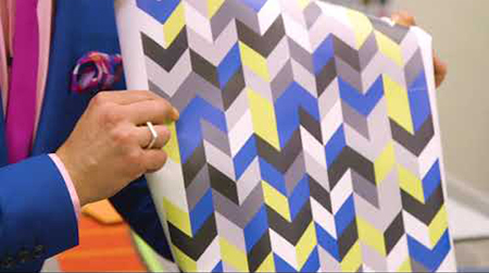 Nick Verreos holding up wallpaper