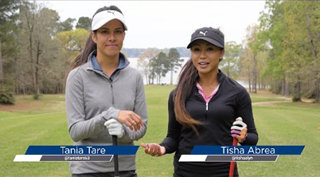 Two brunette woman in visors golfing