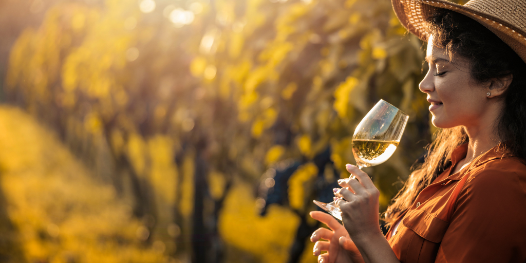 Woman drinking wine in a vineyard