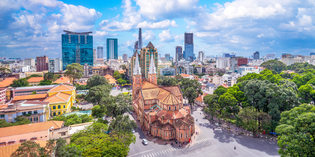 Skyline of Ho Chi Minh City during the day with white fluffy clouds in the sky