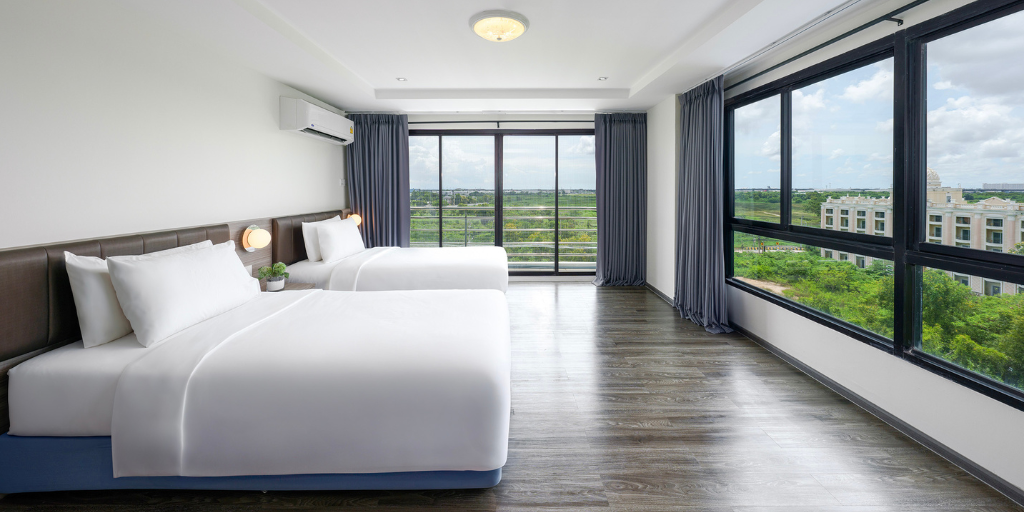 Guestroom of the SureStay by Best Western Iconic Suvarnabhumi featuring beautiful wood floors and an incredible view of lush greenery