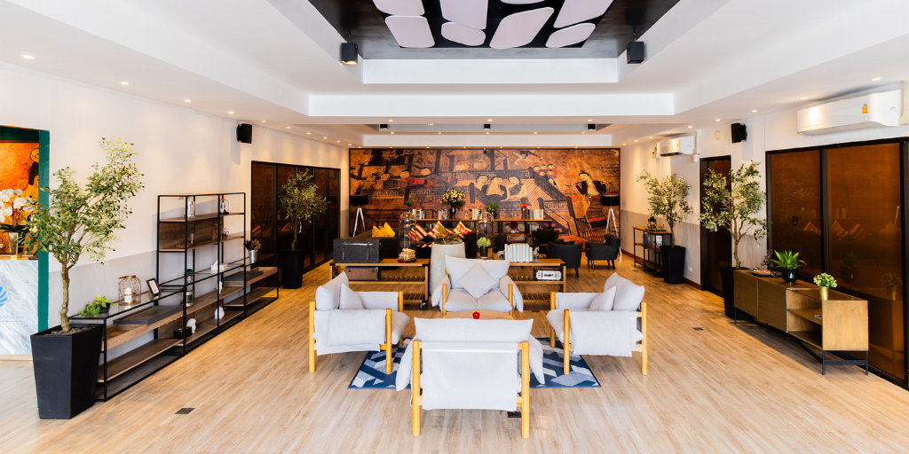 Lobby of the SureStay by Best Western Iconic Suvarnabhumi with modern white chairs and a colorful art piece behind it