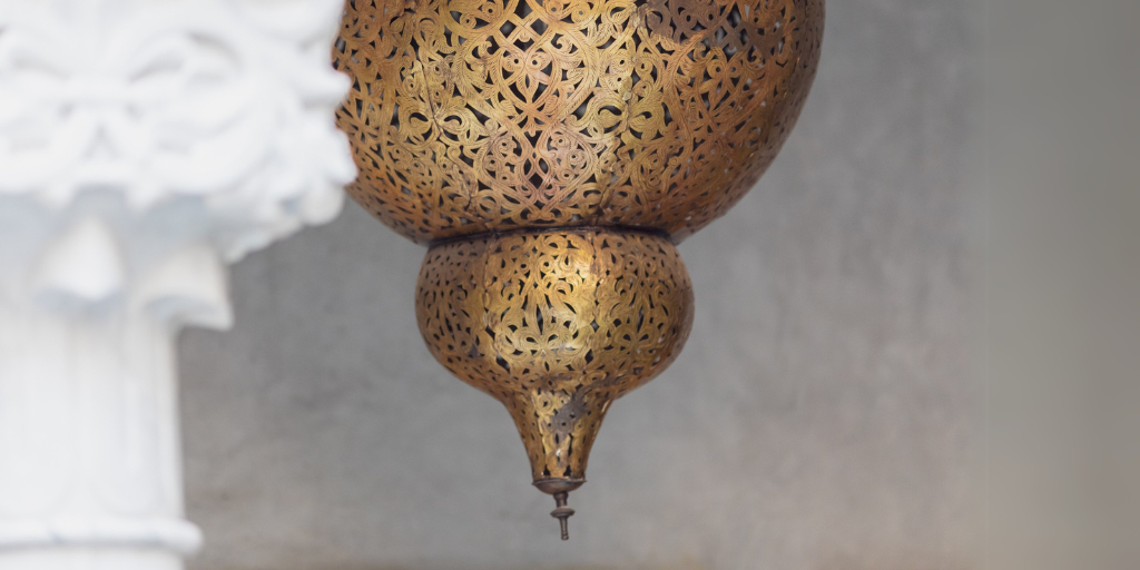 Gold metal sculpture pointing down