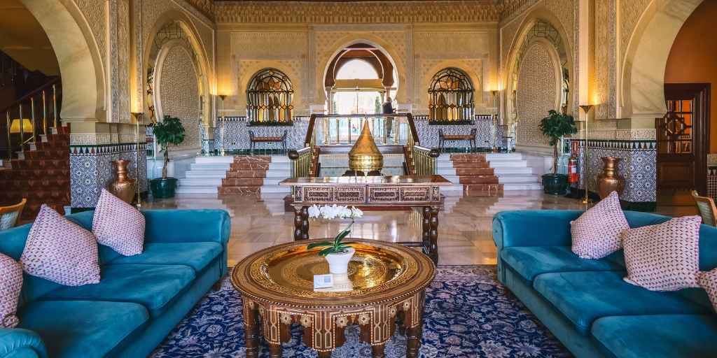 WorldHotels Luxury property with a vibrant lobby featuring green couches on both side of the room
