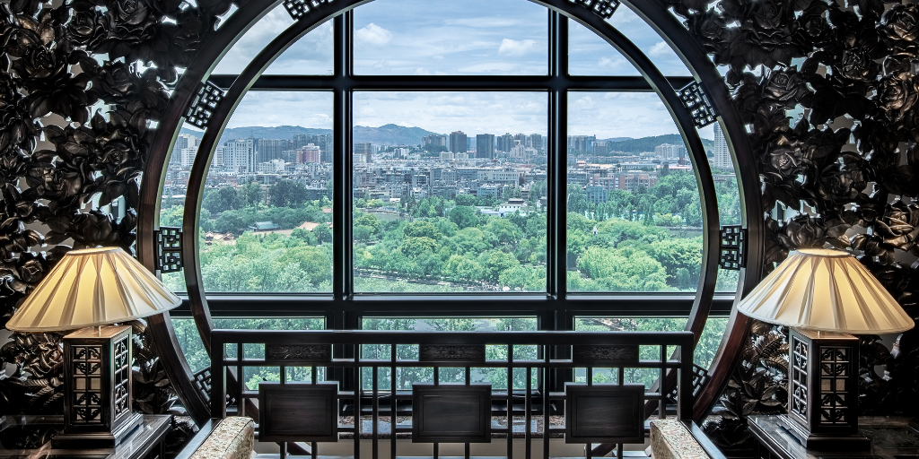 WorldHotels Elite property featuring a dynamic view through a window showing green trees