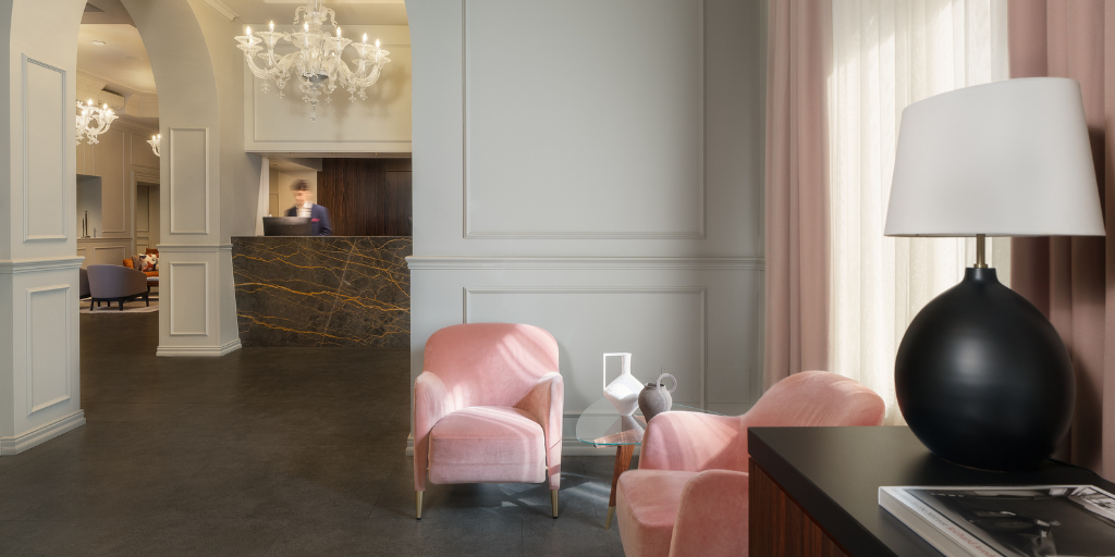 Hotel room with two pink accent chairs