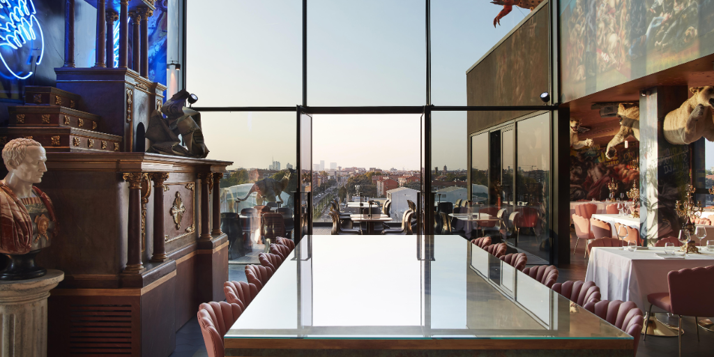 Collini hotel guestroom with a large window and T-rex outside