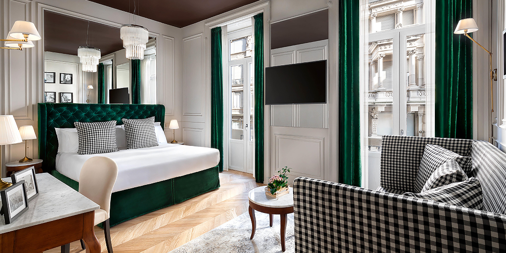 Luxury designed hotel room with green accent curtains