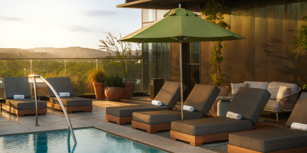 Pool chairs and umbrella at The Loren Austin
